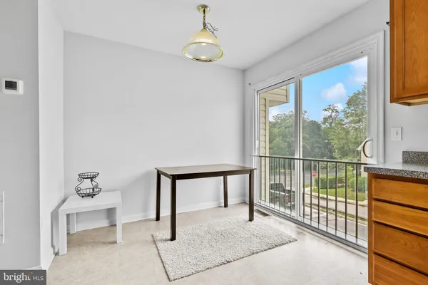 a view of a room with a window and ceiling fan