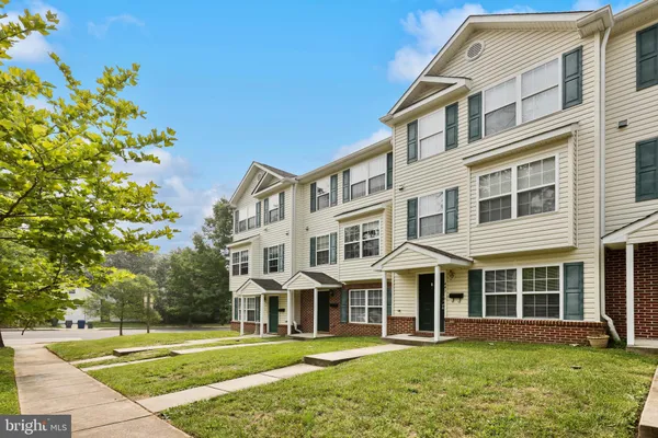 a front view of a building with a garden