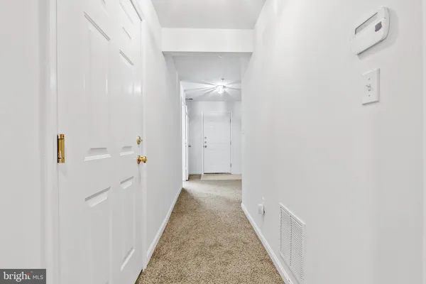 a view of a hallway with white walls