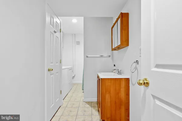 a bathroom with a sink a mirror and a bathtub