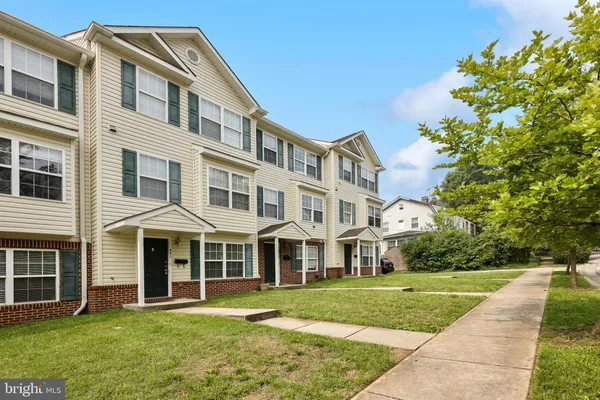 a front view of a building with a garden