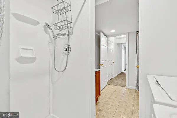 a bathroom with a shower and a glass door