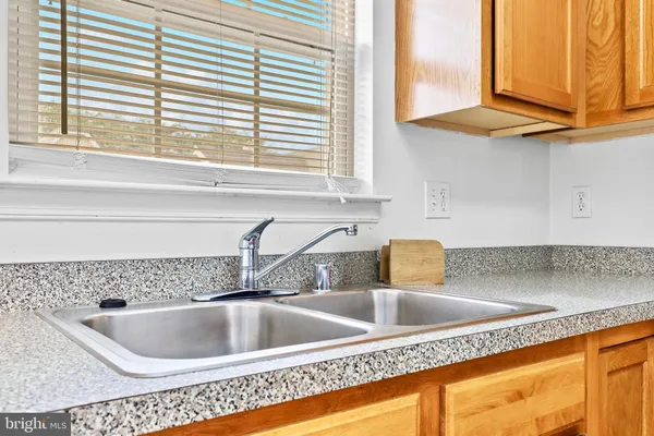a kitchen with a sink a counter and cabinets