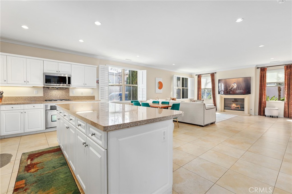 110 Blaze Irvine, CA 92618 - Photo 12 of 28 a kitchen with granite countertop a sink stove top oven and cabinets