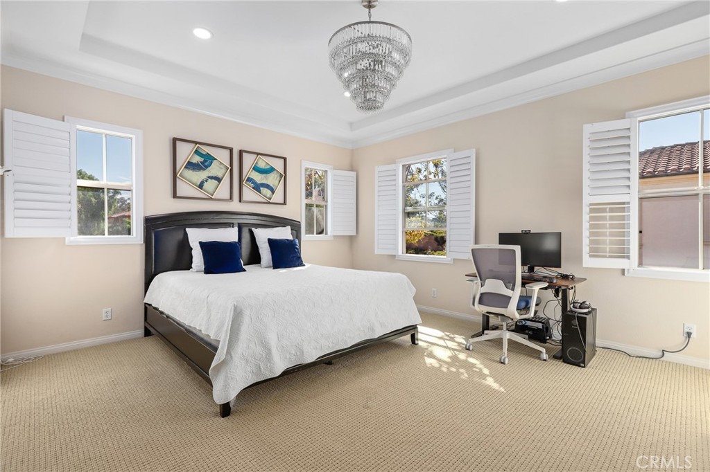 110 Blaze Irvine, CA 92618 - Photo 16 of 28 a bedroom with a bed a table and chair