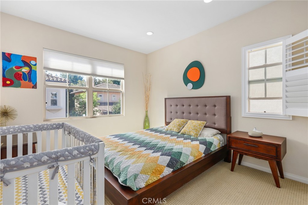 110 Blaze Irvine, CA 92618 - Photo 22 of 28 a bedroom with a bed and a window in it