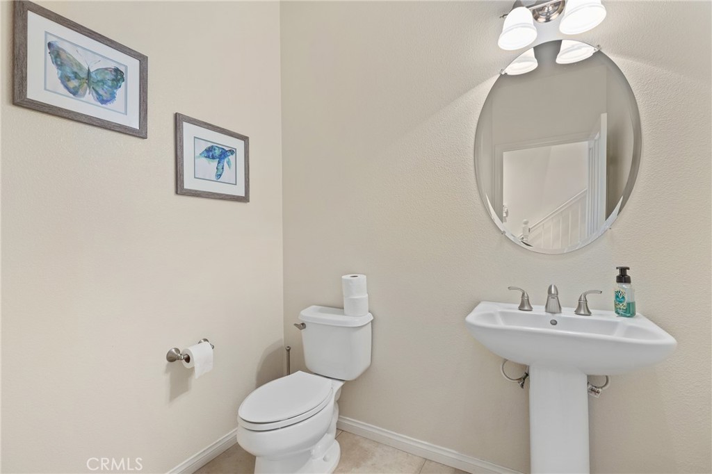 110 Blaze Irvine, CA 92618 - Photo 24 of 28 a bathroom with a toilet sink and mirror