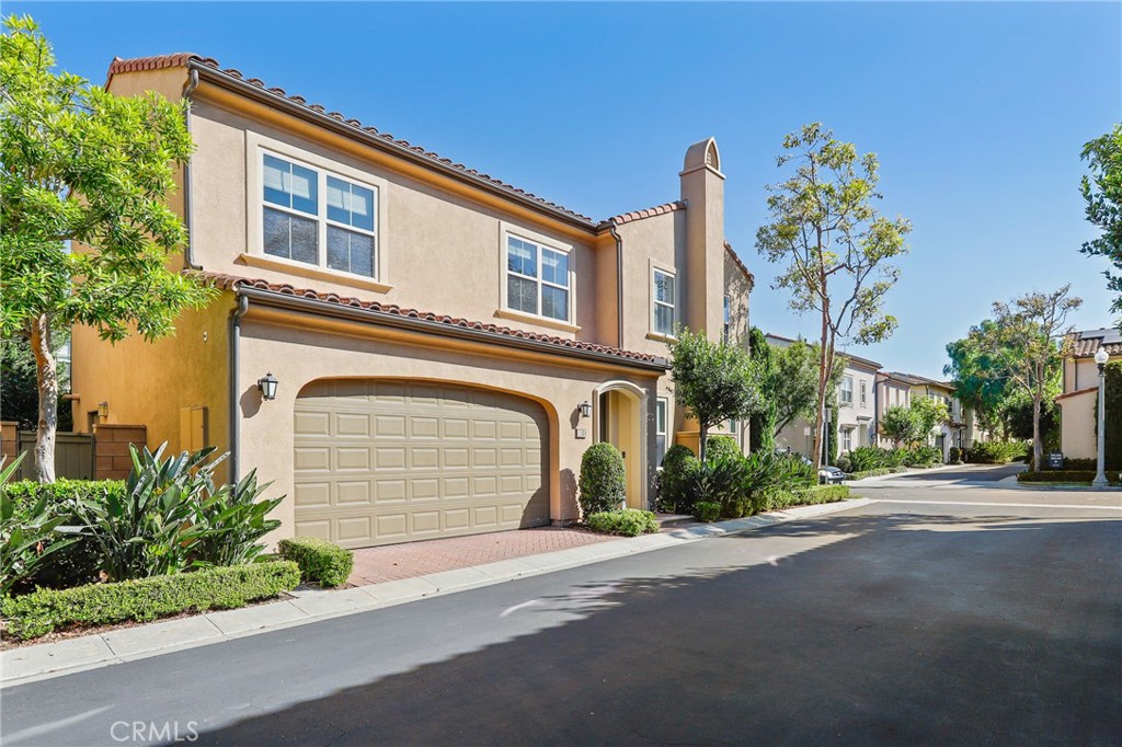 110 Blaze Irvine, CA 92618 - Photo 3 of 28 a front view of a house with a yard and garage