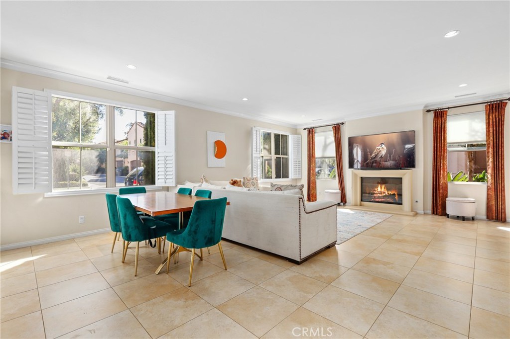 110 Blaze Irvine, CA 92618 - Photo 7 of 28 a living room with furniture a dining table and a large window