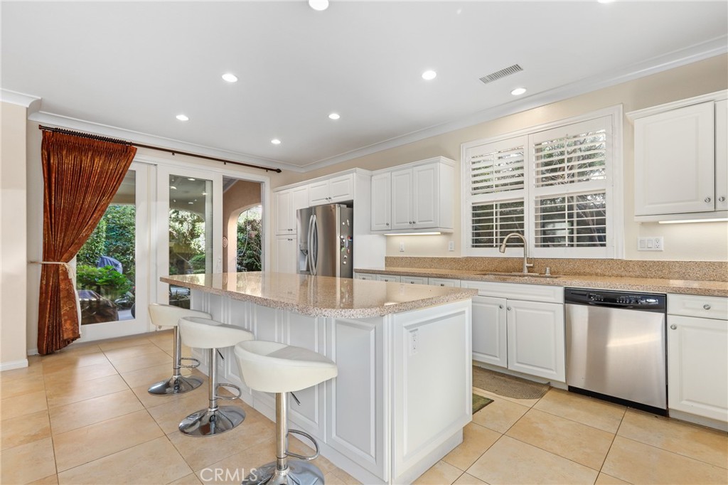 110 Blaze Irvine, CA 92618 - Photo 9 of 28 a kitchen with stainless steel appliances granite countertop a stove a sink and a refrigerator