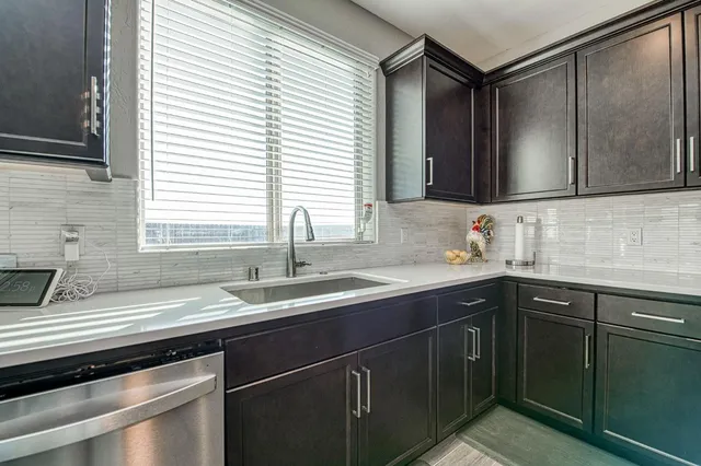 a kitchen with stainless steel appliances kitchen island granite countertop a sink and cabinets