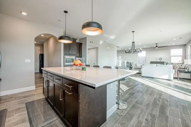 a living room with furniture a chandelier and a window