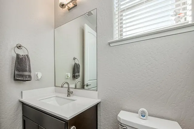 a bathroom with a double vanity sink toilet and shower
