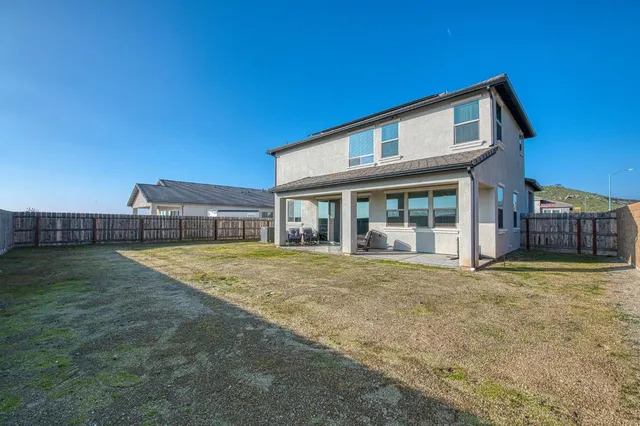 a view of a balcony with wooden floor and fence