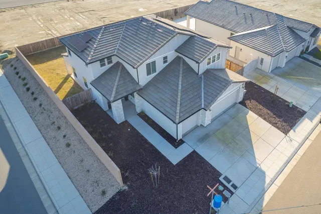 an aerial view of residential houses with outdoor space