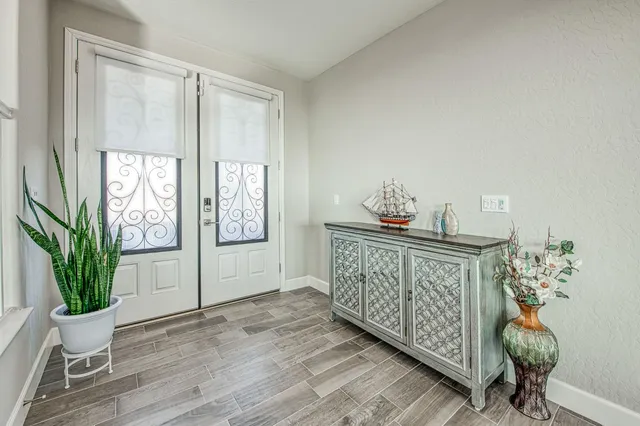 a bedroom with furniture window and wooden floor