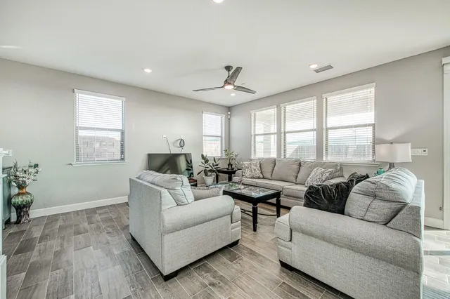 a living room with furniture and a large window