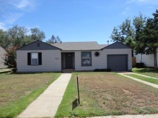 3313 27th Street Lubbock, TX 79410 - Photo 1 of 8 a front view of a house with a yard and garage