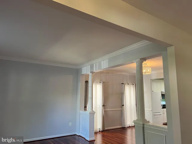 an empty room with wooden floor and a door