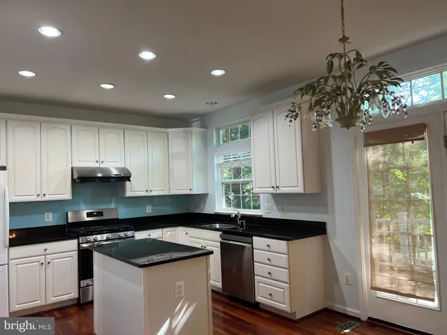 a kitchen that has a sink and a stove in it