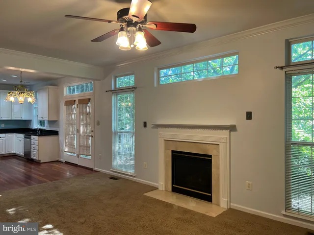 a view of a livingroom with a fireplace and a window