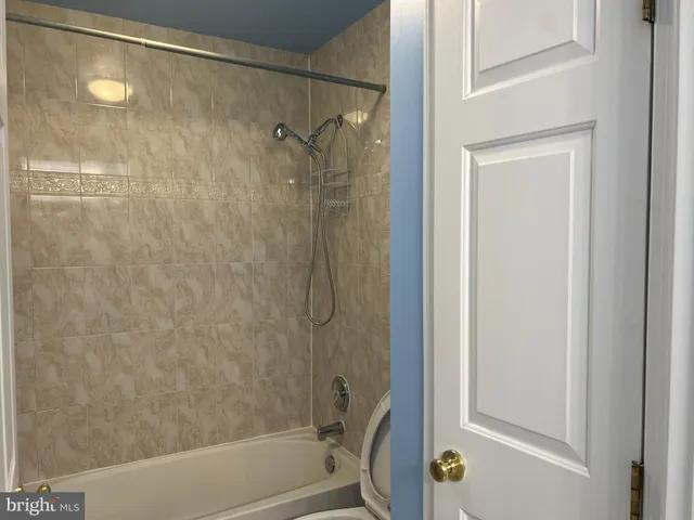 a bathroom with a shower and a bath tub