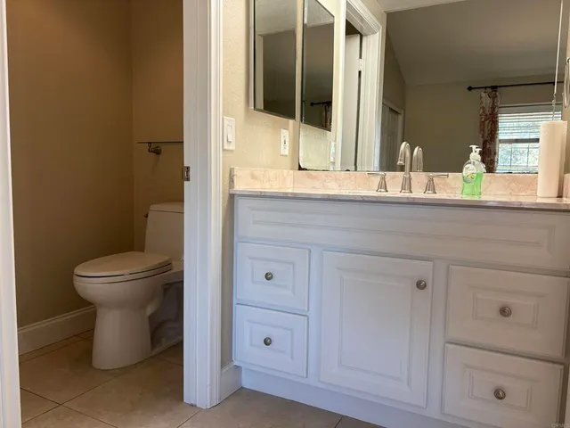 a bathroom with a granite countertop sink mirror and double