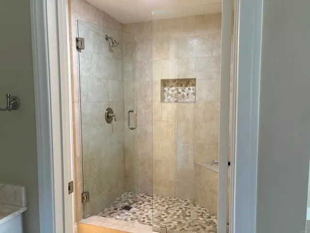 a spacious bathroom with a toilet a sink and mirror