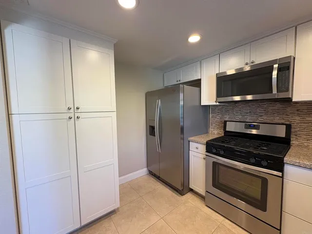 a kitchen with a refrigerator stove and microwave