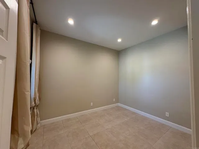 an empty room with closet and wooden door