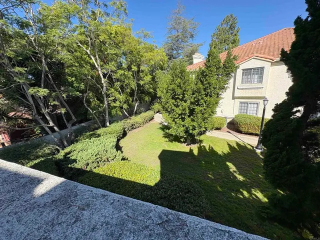 a view of a garden with a house