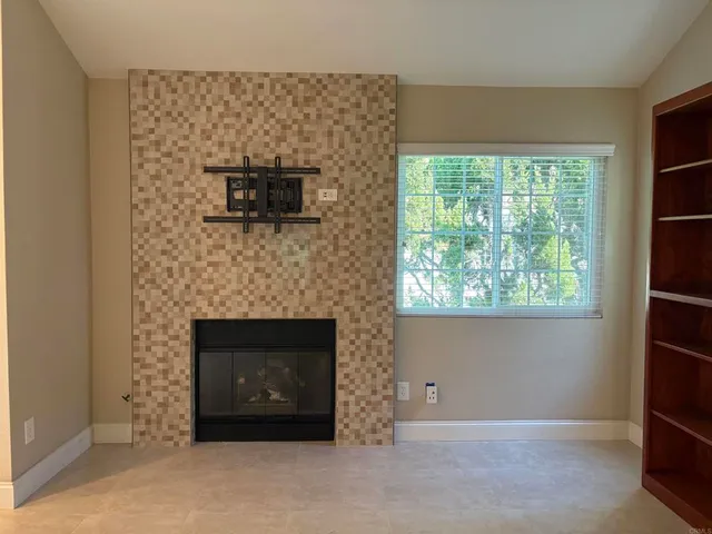 a living room with a fireplace and a window