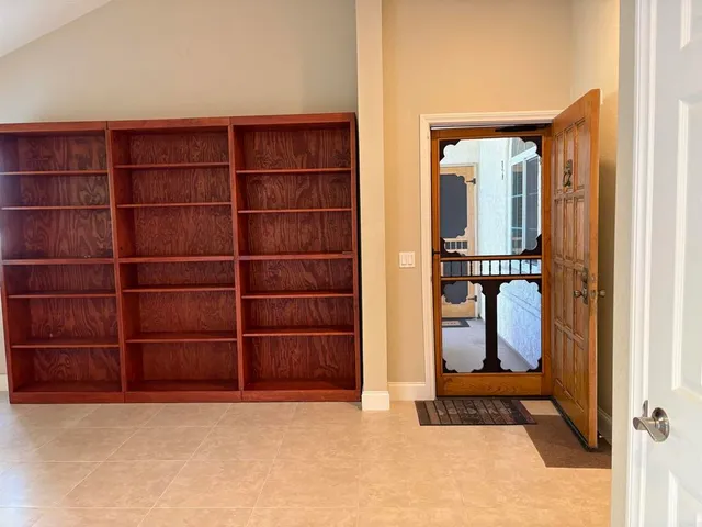 a view of a kitchen with furniture and a ceiling fan
