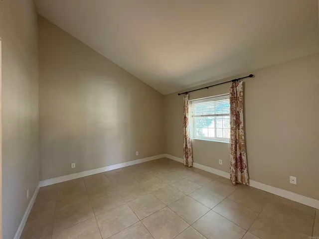a view of an empty room with glass door