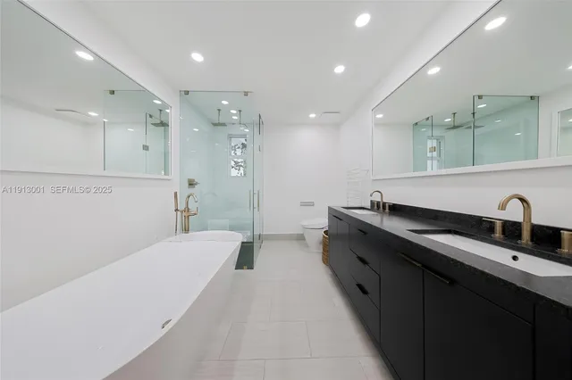 a large kitchen with stainless steel appliances a sink dishwasher and a refrigerator