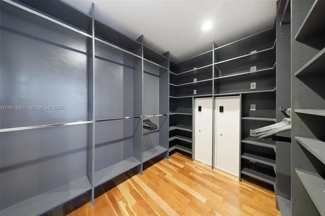 a view of walk in closet with clothes and shoes