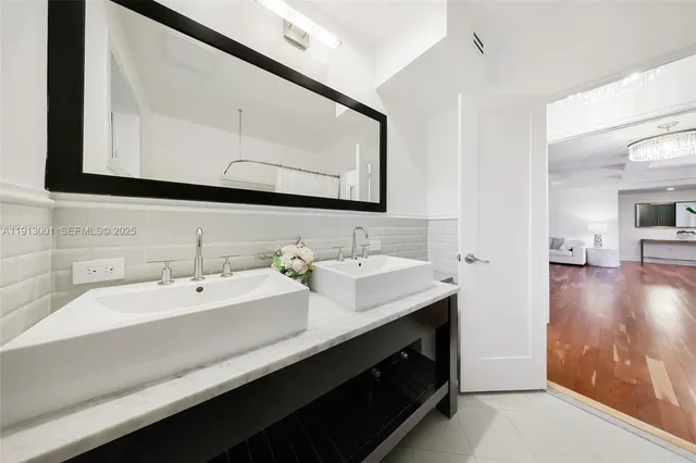 a bathroom with a double vanity sink and a mirror