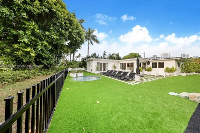 a front view of a house with yard patio and green space
