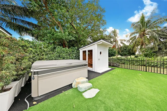a view of a house with a yard and sitting area