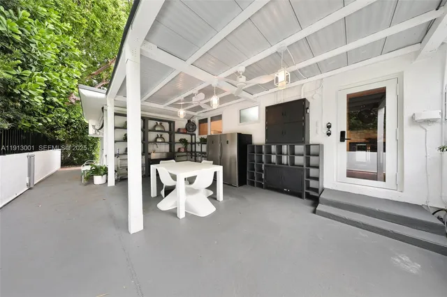 a view of a patio with table and chairs and potted plants