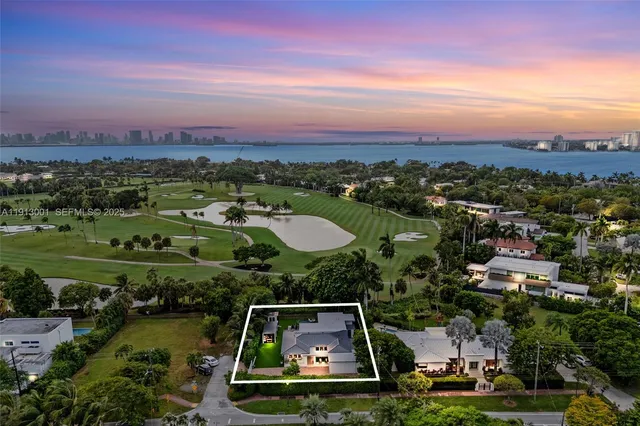 an aerial view of residential houses with outdoor space and river