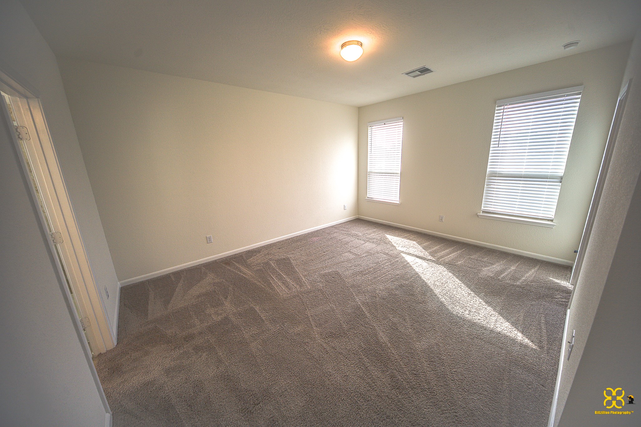 5820 Bluebonnet Lane Rosenberg, TX 77469 - Photo 23 of 43 This Master Bedroom features neutral walls and carpet, with two large windows providing ample natural light.