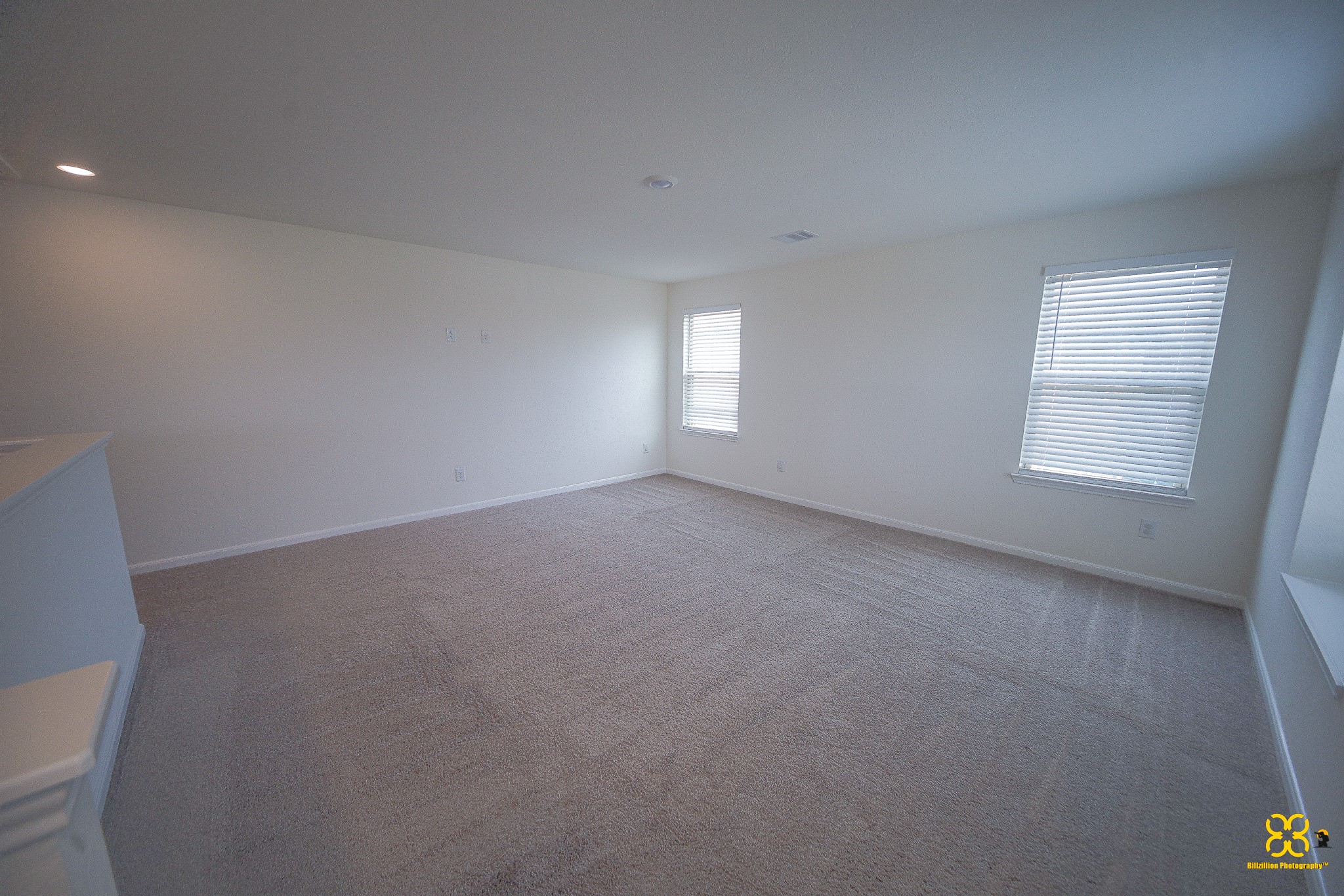 5820 Bluebonnet Lane Rosenberg, TX 77469 - Photo 29 of 43 This spacious, carpeted Game room features neutral walls and ample natural light from two windows, creating a bright and inviting atmosphere. Ideal for a living area or family room.