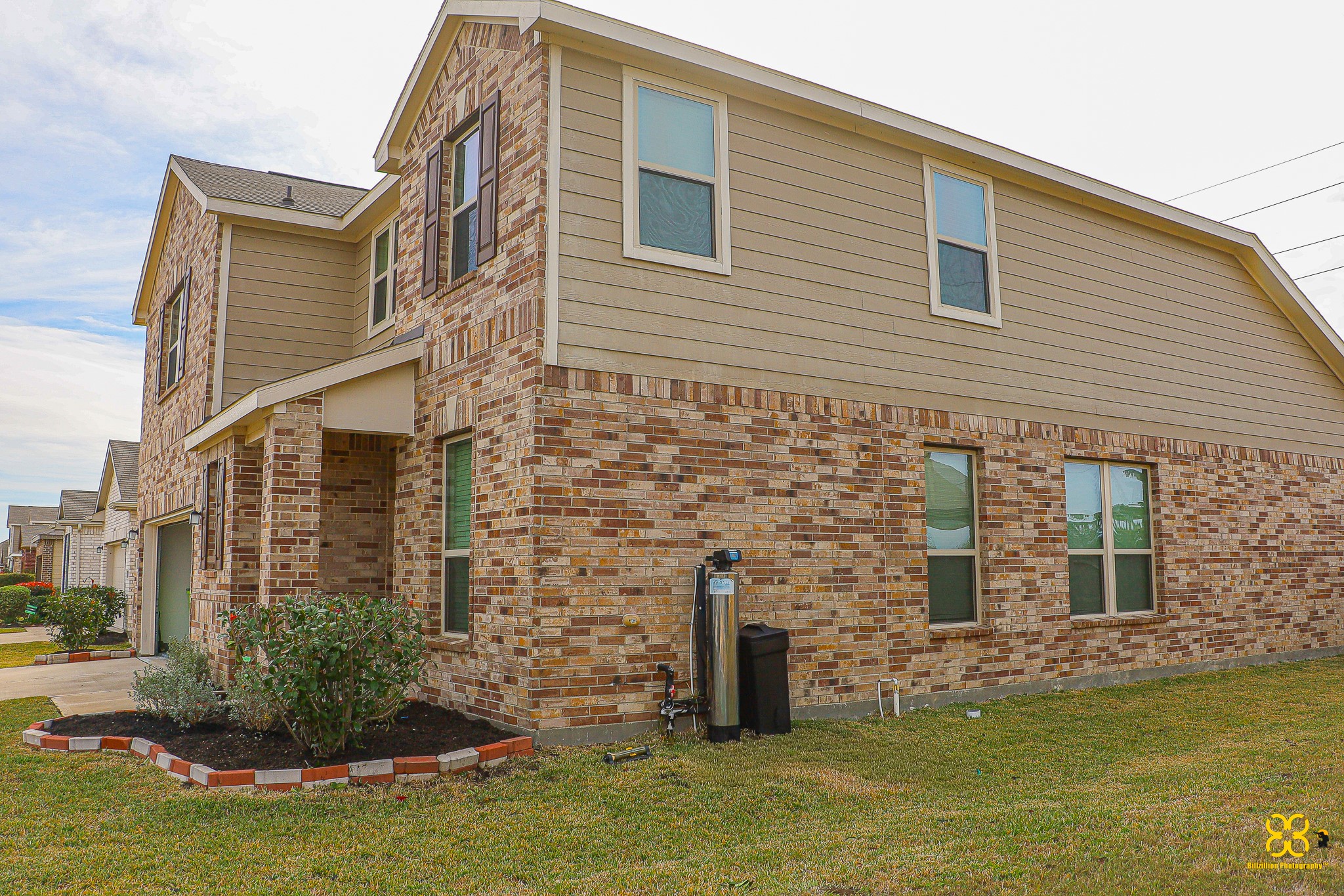 5820 Bluebonnet Lane Rosenberg, TX 77469 - Photo 8 of 43 This is a modern home with a combination of brick and siding exterior. It features multiple windows for natural light and a well-maintained lawn. The house has an attached garage and a charming front garden, offering great curb appeal.