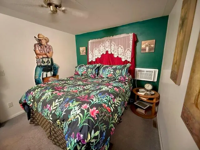 a bed sitting in a bedroom next to a lamp