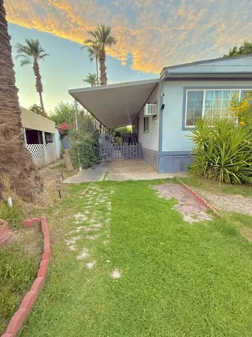 a view of a backyard with plants and a patio