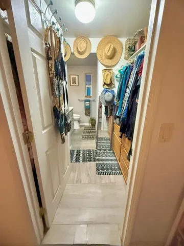 a view of entryway and hall with wooden floor