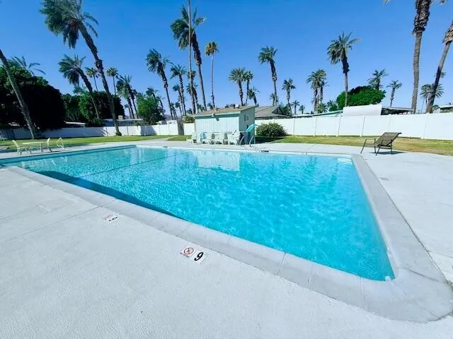 a view of a swimming pool with a yard