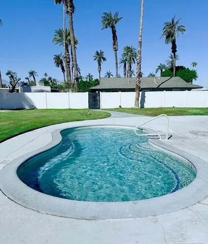 a view of a swimming pool with a yard