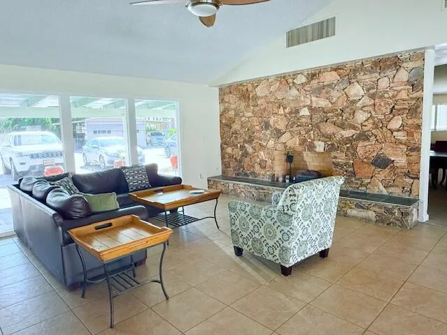 a living room with furniture and a floor to ceiling window